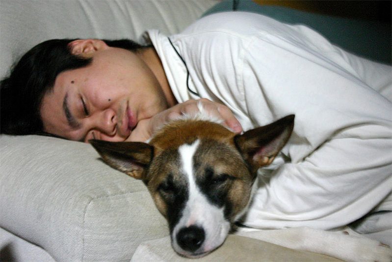 Man sleeping with his dog